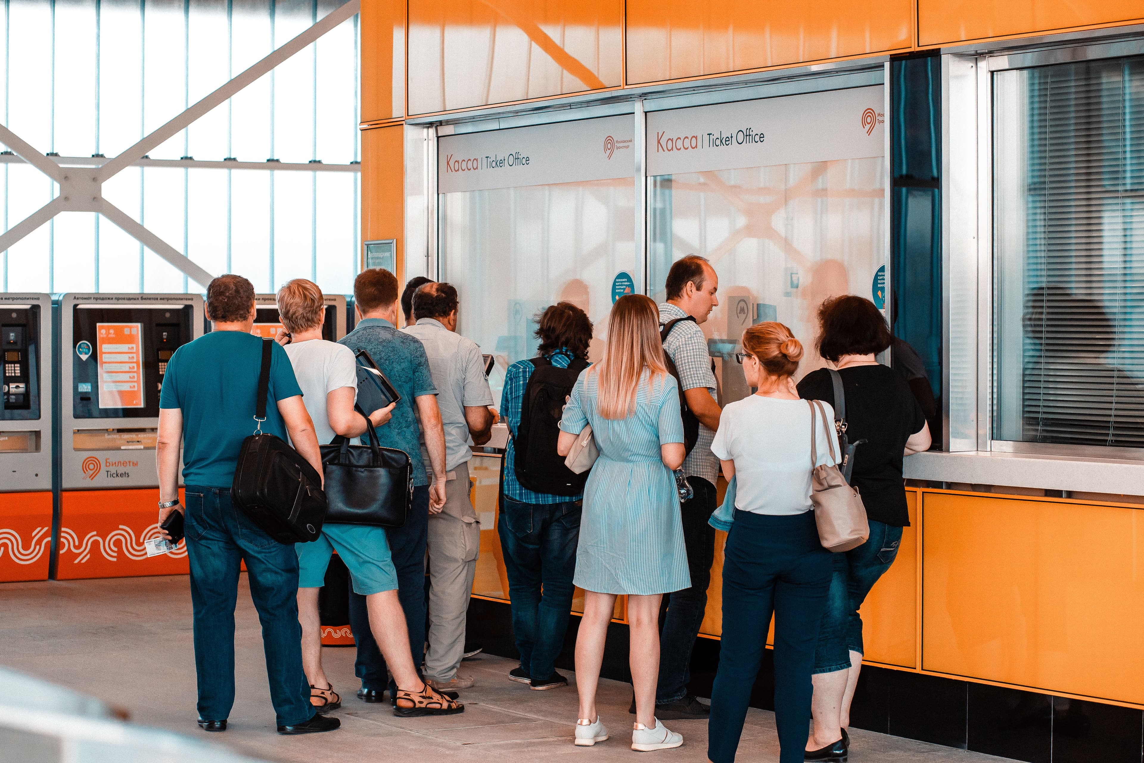 People waiting in line at a ticket office